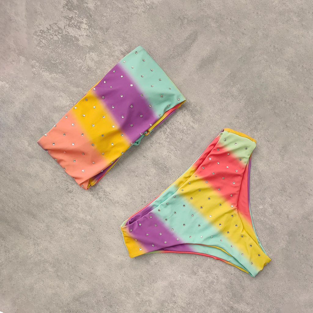 An elegant reversible two-piece swimwear featuring a bandeau top with cross-halter detail and a high-waisted bottom, designed for versatile, feminine summer style