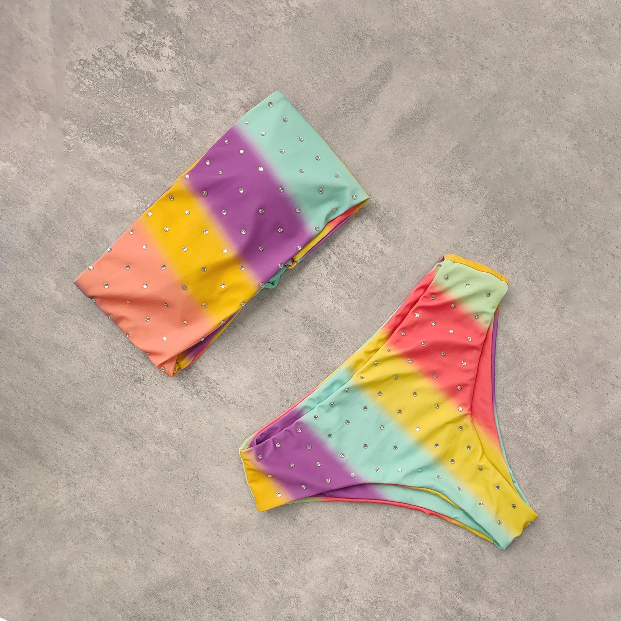 An elegant reversible two-piece swimwear featuring a bandeau top with cross-halter detail and a high-waisted bottom, designed for versatile, feminine summer style