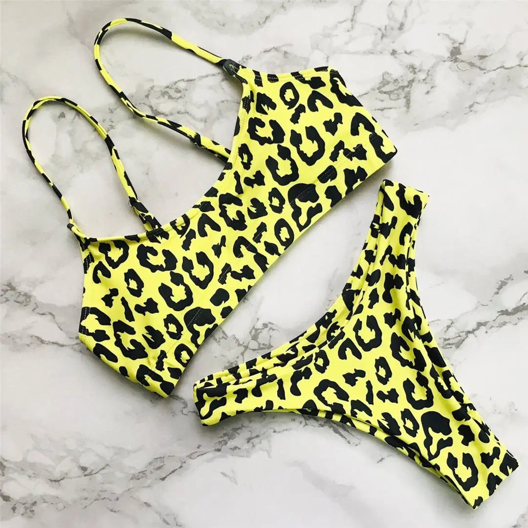 A refined leopard-print two-piece swimwear with a flattering Brazilian cut, designed to enhance feminine elegance and confident beach style
