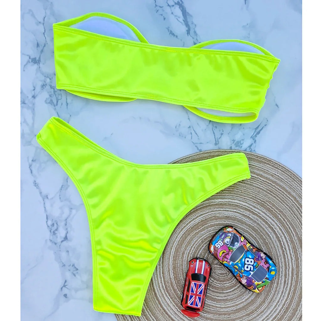 An elegant two-piece swimwear featuring a sleek strapless bandeau top with padded support, designed for a feminine, minimal, and confident beach look
