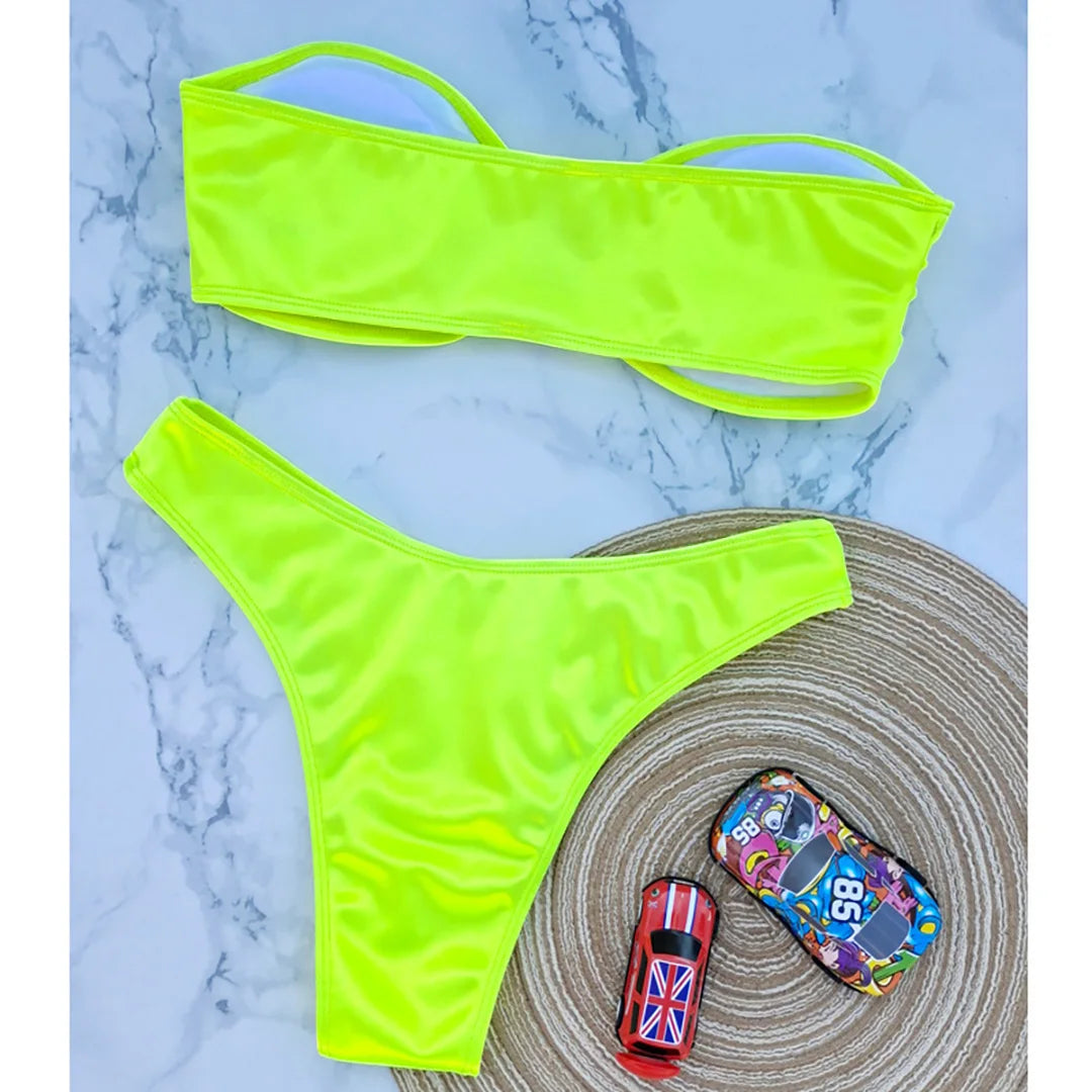An elegant two-piece swimwear featuring a sleek strapless bandeau top with padded support, designed for a feminine, minimal, and confident beach look