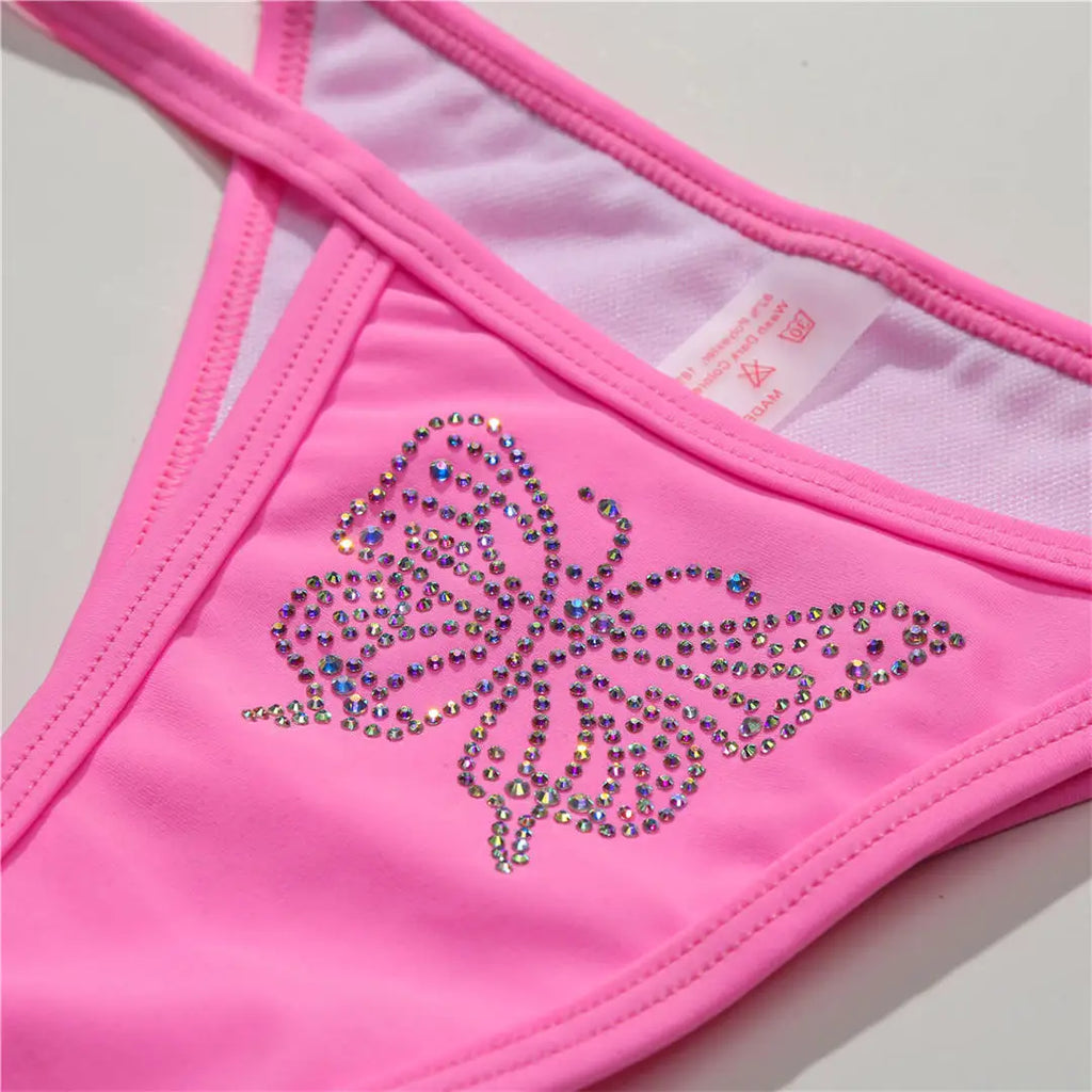 An elegant halter two-piece swimwear adorned with sparkling butterfly rhinestone details, designed to bring a feminine and radiant touch to your beach style