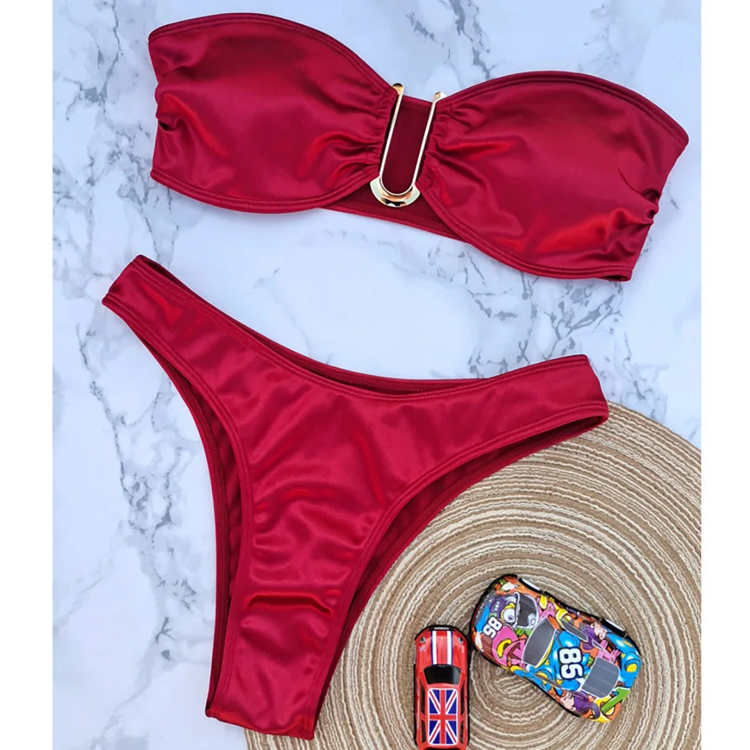 An elegant two-piece swimwear featuring a sleek strapless bandeau top with padded support, designed for a feminine, minimal, and confident beach look