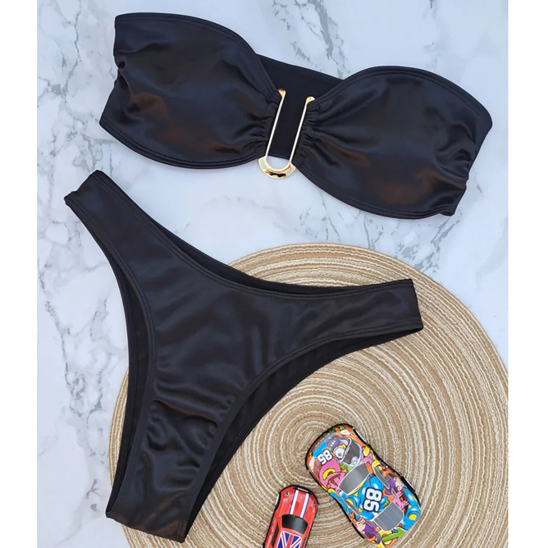 An elegant two-piece swimwear featuring a sleek strapless bandeau top with padded support, designed for a feminine, minimal, and confident beach look