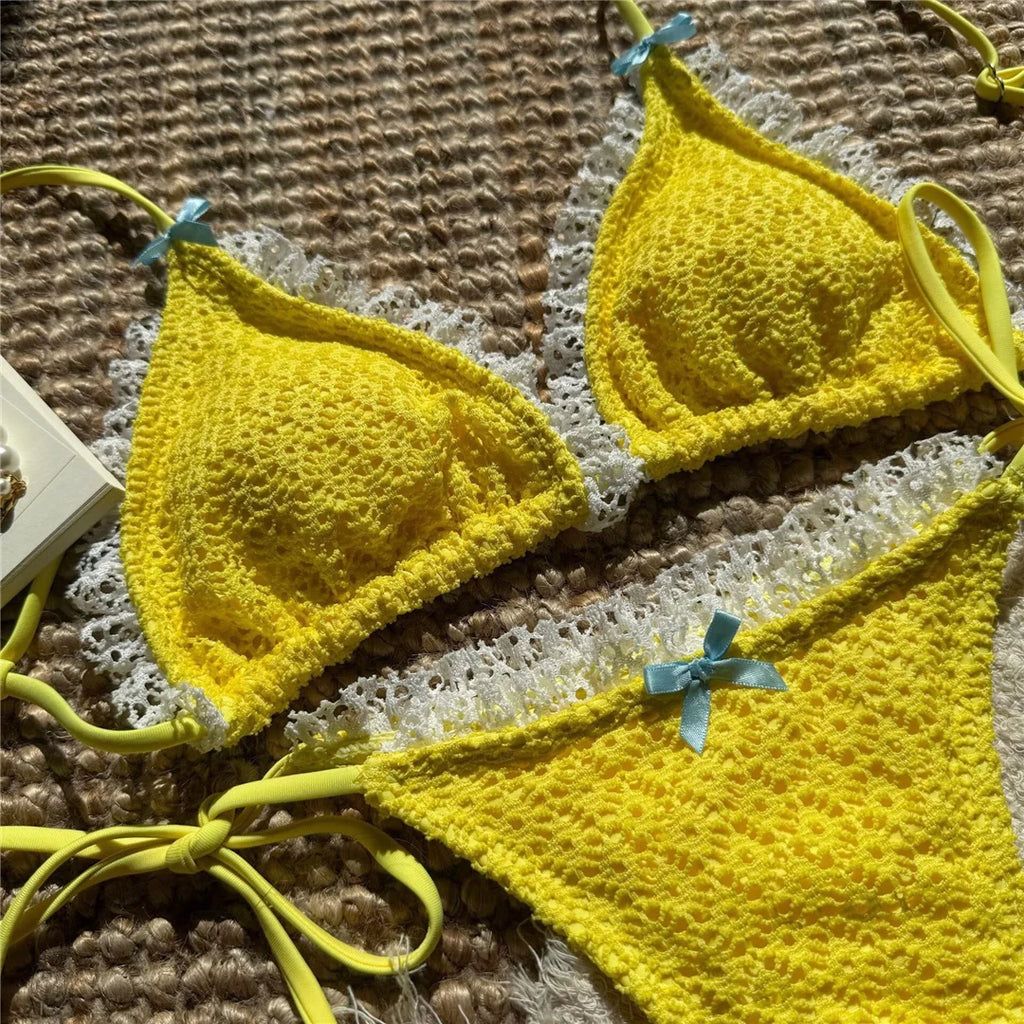 An elegant two-piece swimwear featuring delicate lace detailing, a halter neckline, and a mini thong high-cut leg design, crafted for a feminine and confident beach look
