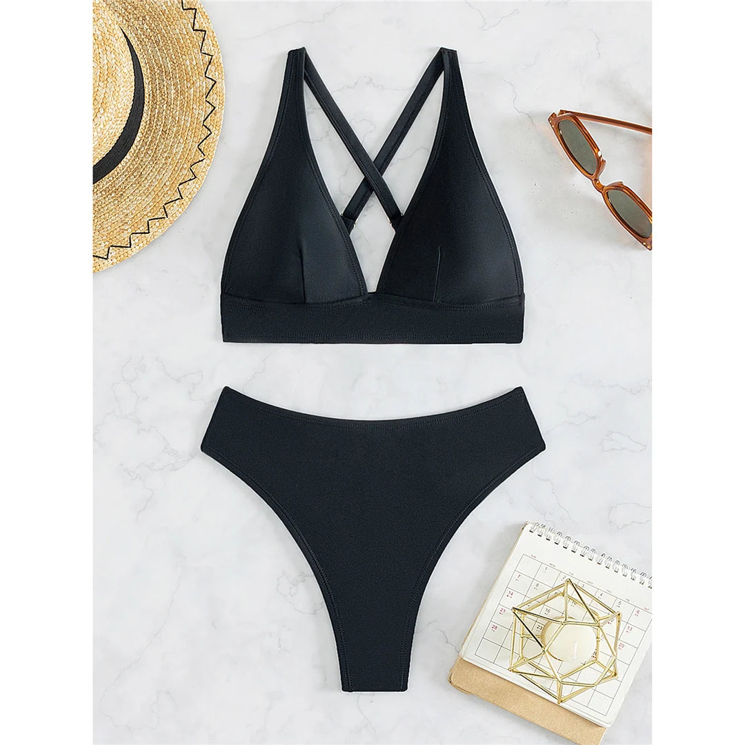A sleek cross-back two-piece swimwear with a minimal thong cut, designed for a bold yet elegant feminine beach look
