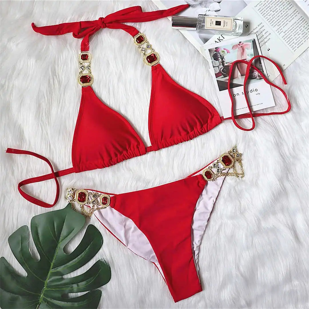 An elegant two-piece swimwear embellished with luxurious rhinestone detailing, designed to deliver a radiant and feminine beach look with a touch of refined glamour
