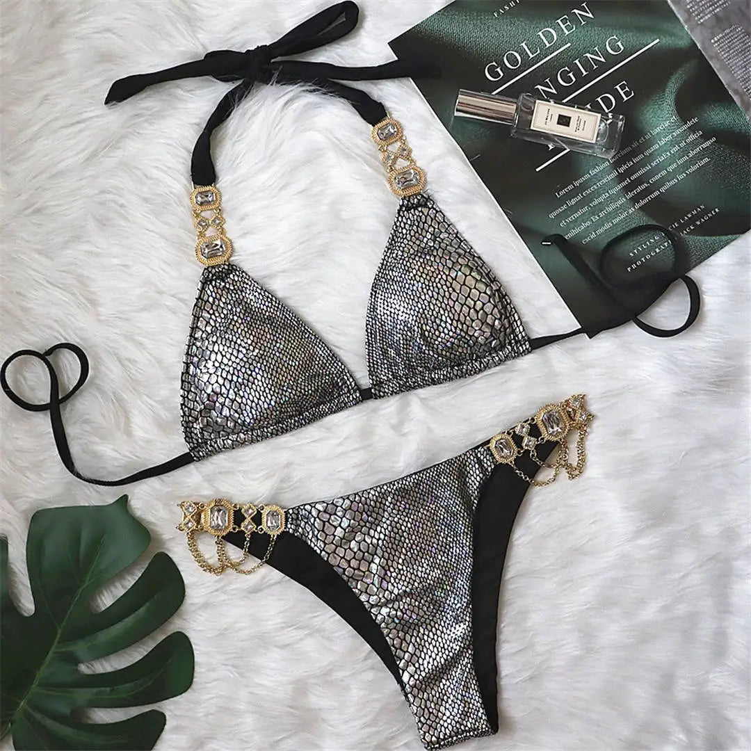 An elegant two-piece swimwear embellished with luxurious rhinestone detailing, designed to deliver a radiant and feminine beach look with a touch of refined glamour