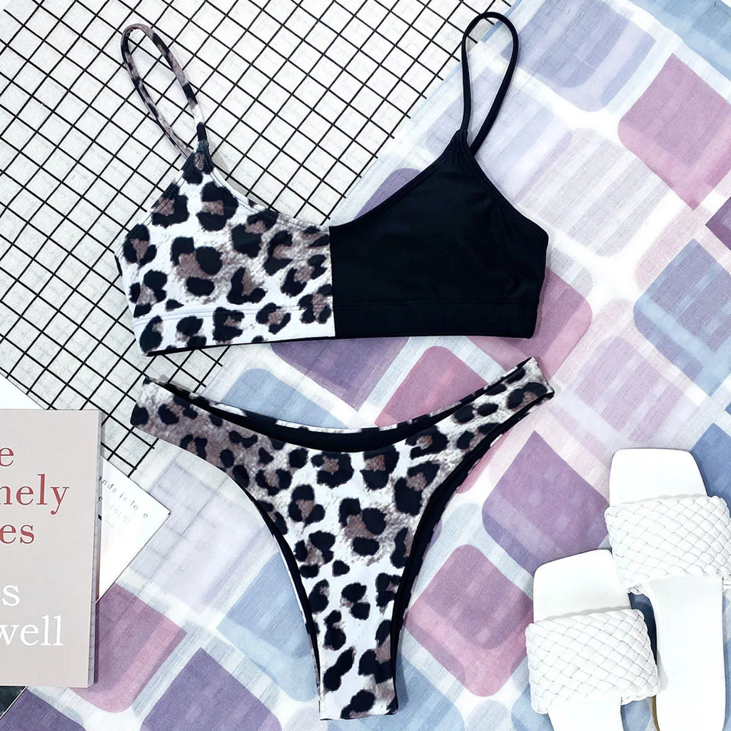 A refined leopard-print two-piece swimwear with a flattering Brazilian cut, designed to enhance feminine elegance and confident beach style