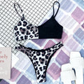 A refined leopard-print two-piece swimwear with a flattering Brazilian cut, designed to enhance feminine elegance and confident beach style