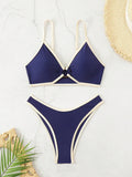 A bold yet refined Brazilian two-piece swimwear featuring a halter top and thong cut, designed for a confident, feminine beach statement