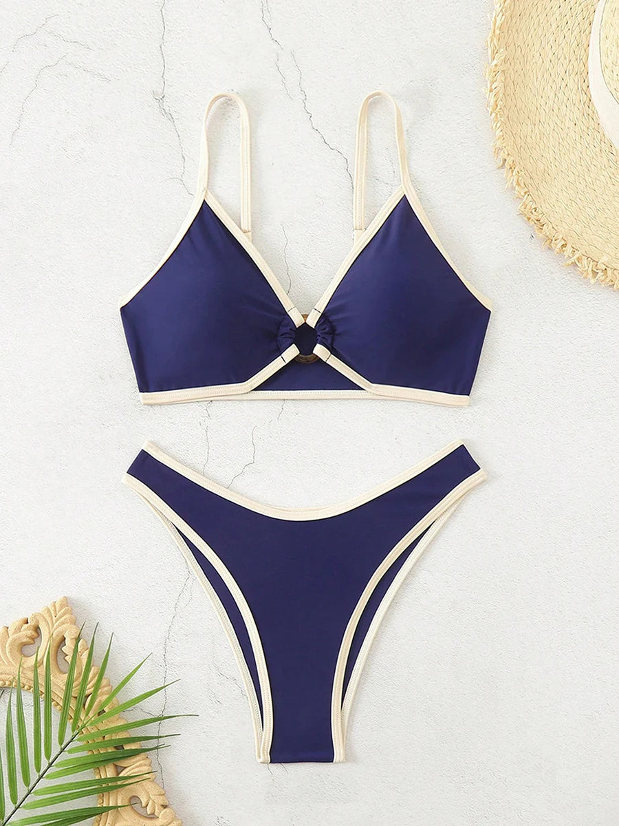 A bold yet refined Brazilian two-piece swimwear featuring a halter top and thong cut, designed for a confident, feminine beach statement