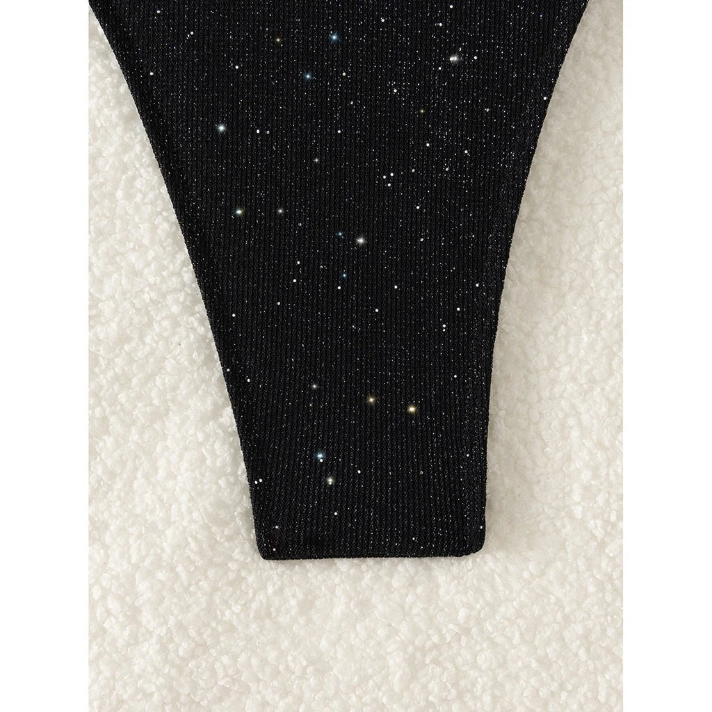An elegant two-piece swimwear featuring a sparkling glitter finish, halter neckline, and high-leg cut, designed for a radiant and confident feminine beach look