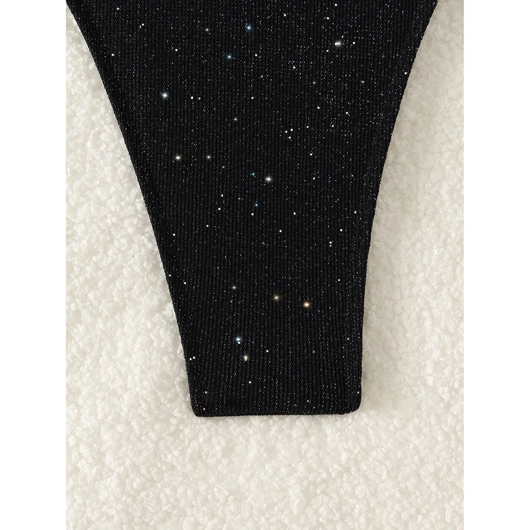 An elegant two-piece swimwear featuring a sparkling glitter finish, halter neckline, and high-leg cut, designed for a radiant and confident feminine beach look