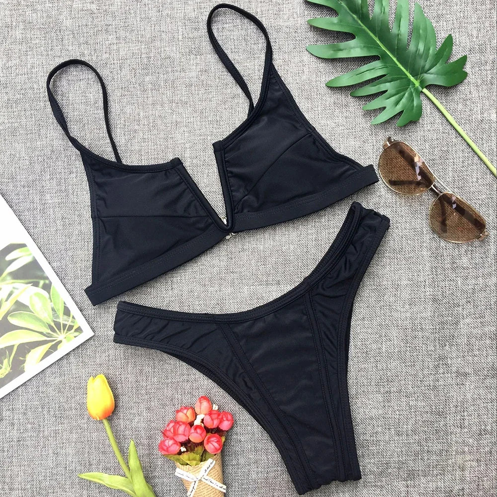 A sleek two-piece swimwear featuring a flattering V-shaped thong bottom and push-up top, designed for a bold yet elegant feminine beach look