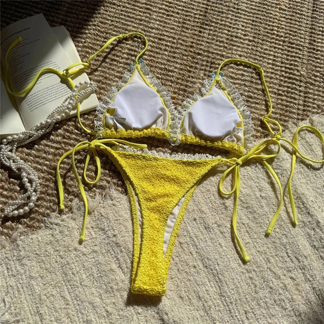 An elegant two-piece swimwear featuring delicate lace detailing, a halter neckline, and a mini thong high-cut leg design, crafted for a feminine and confident beach look