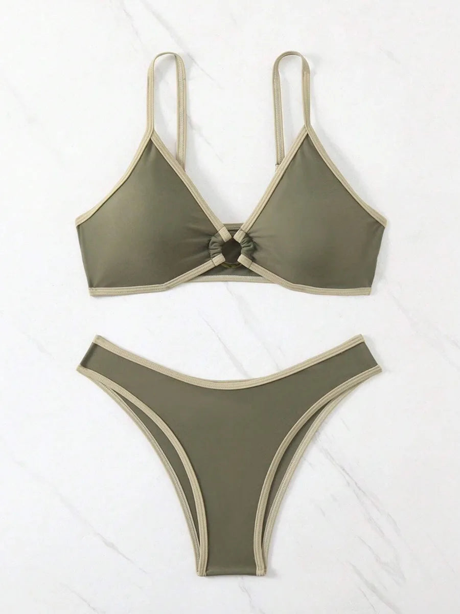 A bold yet refined Brazilian two-piece swimwear featuring a halter top and thong cut, designed for a confident, feminine beach statement