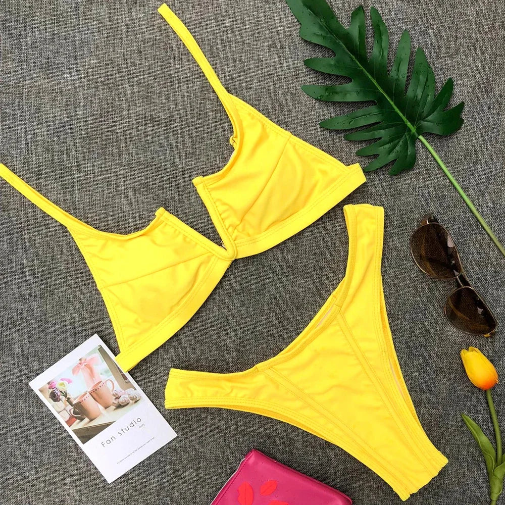 A sleek two-piece swimwear featuring a flattering V-shaped thong bottom and push-up top, designed for a bold yet elegant feminine beach look