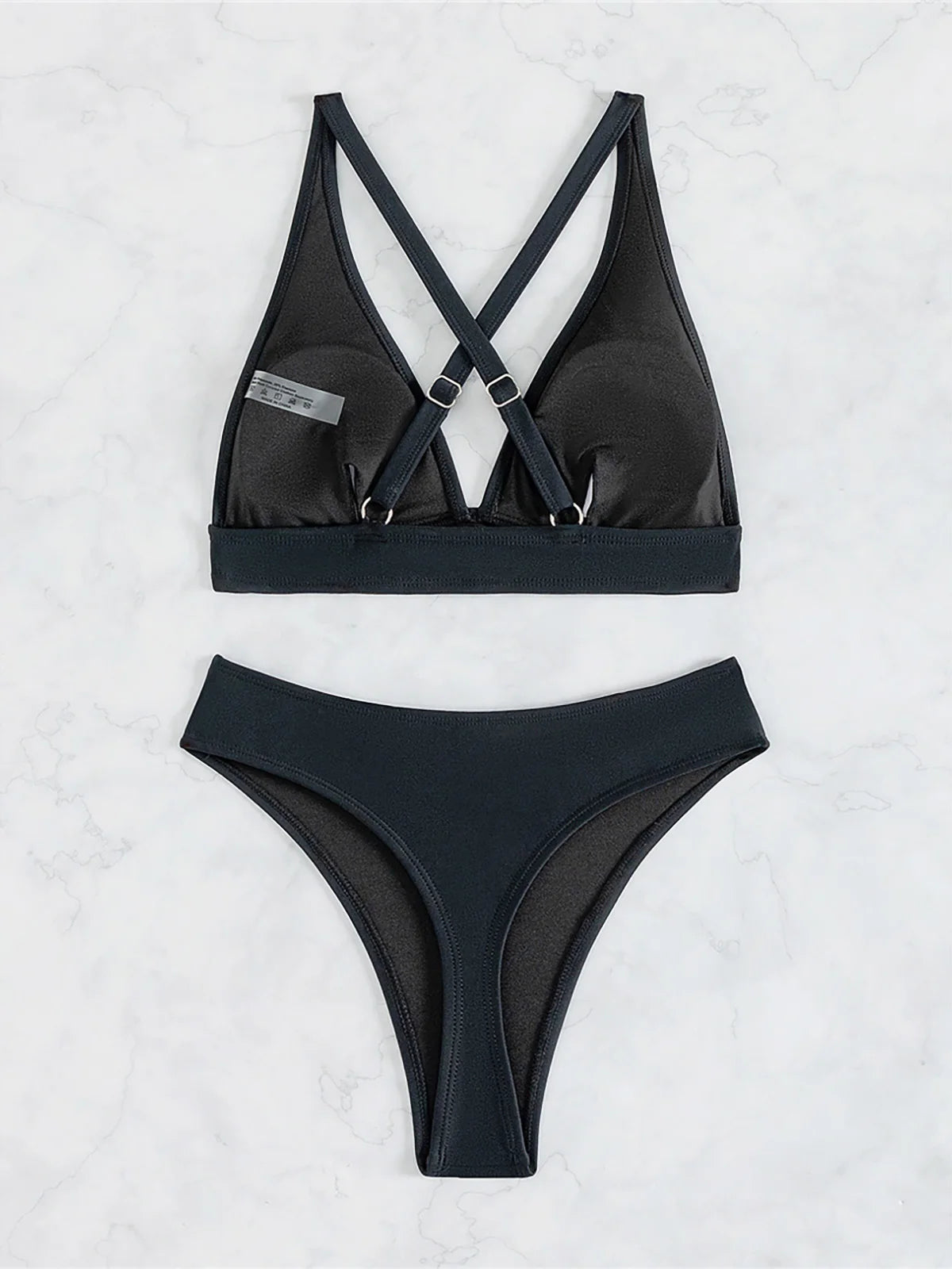 A sleek cross-back two-piece swimwear with a minimal thong cut, designed for a bold yet elegant feminine beach look