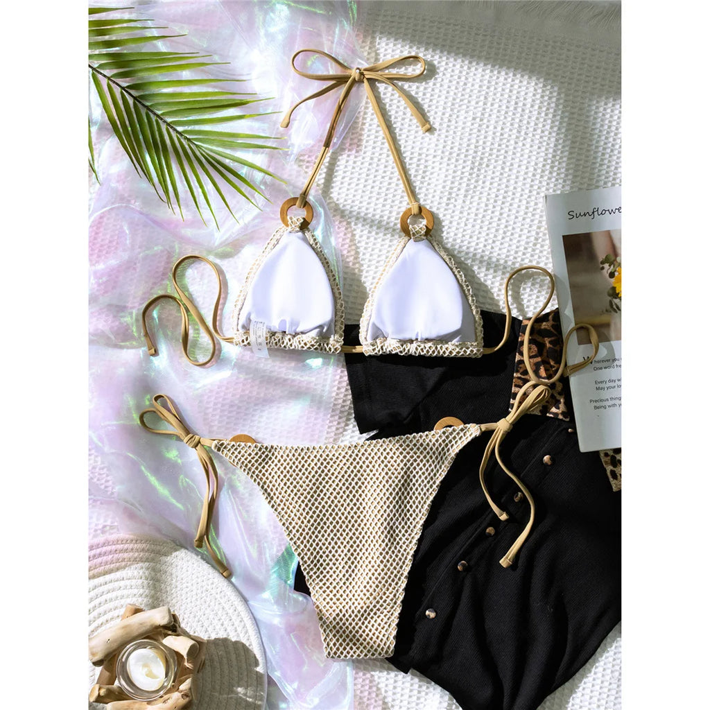 An elegant halter two-piece swimwear featuring sheer mesh and strappy detailing with a flattering high-cut leg, designed for a bold yet feminine beach look
