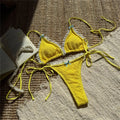An elegant two-piece swimwear featuring delicate lace detailing, a halter neckline, and a mini thong high-cut leg design, crafted for a feminine and confident beach look