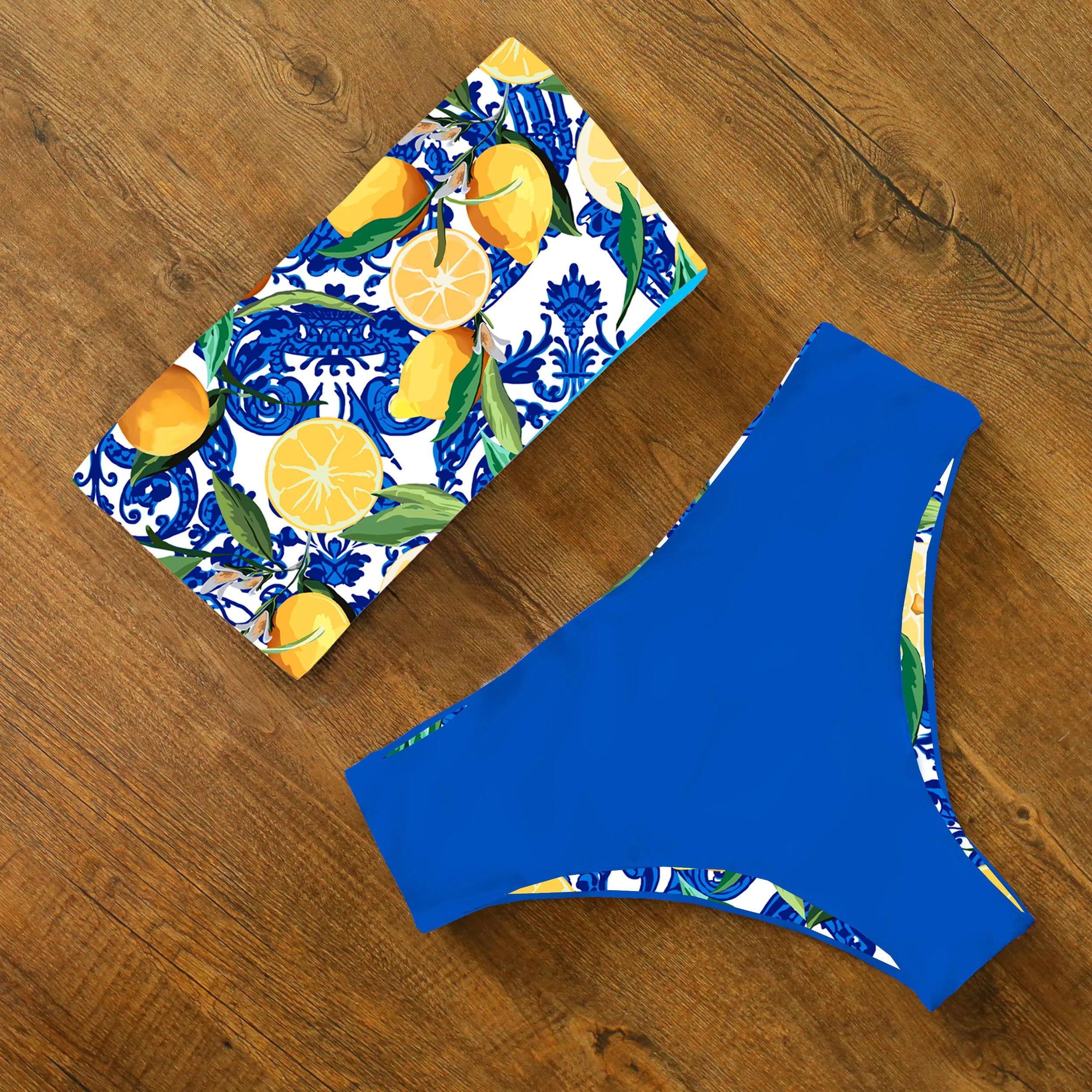 An elegant reversible two-piece swimwear featuring a bandeau top with cross-halter detail and a high-waisted bottom, designed for versatile, feminine summer style