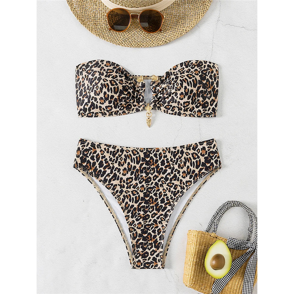An elegant two-piece swimwear featuring a chic leopard print, bandeau top, and high-leg cut, designed for a feminine and confident beach look