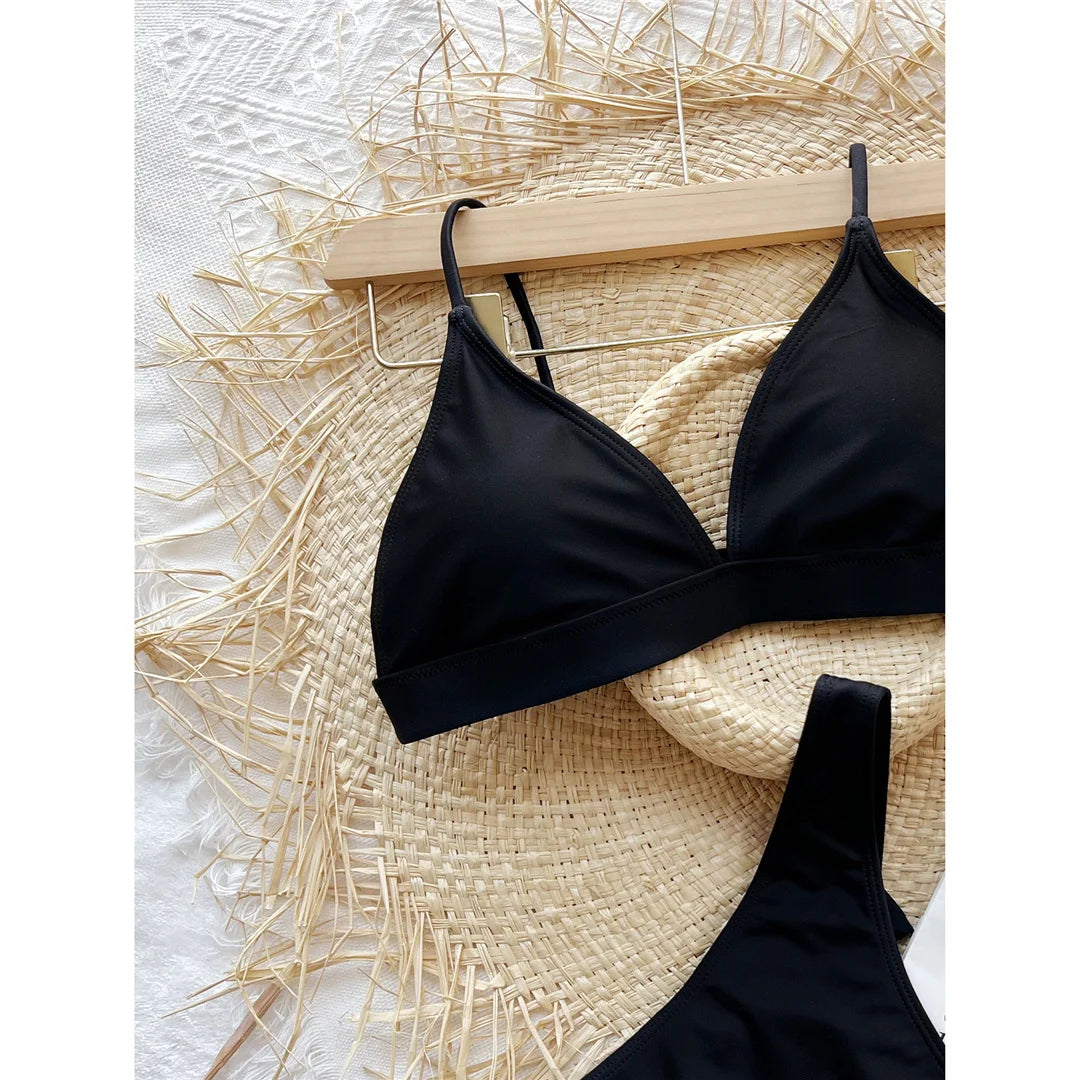 An elegant two-piece swimwear featuring a delicate bow detail, padded top, and flattering high-cut thong design, created for a bold yet feminine beach statement