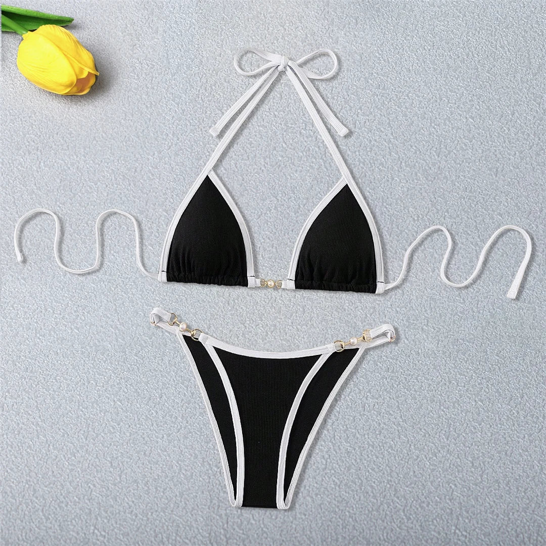 An elegant two-piece swimwear featuring refined pearl accents, a ribbed texture, and a flattering high-cut silhouette, designed for a timeless and feminine beach look