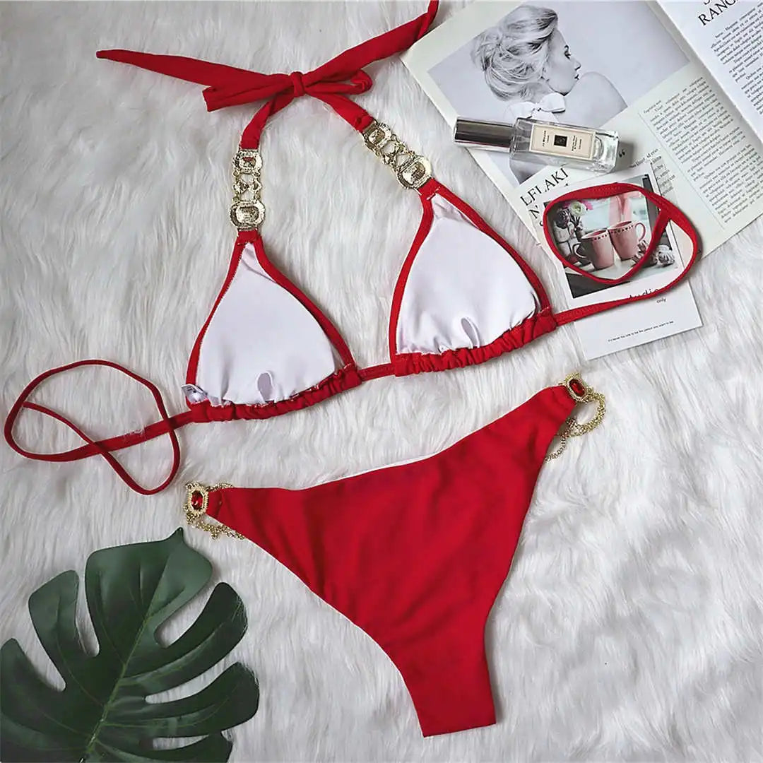 An elegant two-piece swimwear embellished with luxurious rhinestone detailing, designed to deliver a radiant and feminine beach look with a touch of refined glamour
