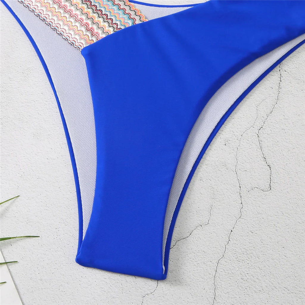 An elegant halter two-piece swimwear featuring refined color-splicing details and a flattering V-neck design, created for a modern, feminine beach style