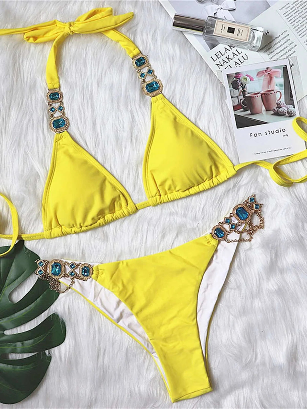 An elegant two-piece swimwear embellished with luxurious rhinestone detailing, designed to deliver a radiant and feminine beach look with a touch of refined glamour