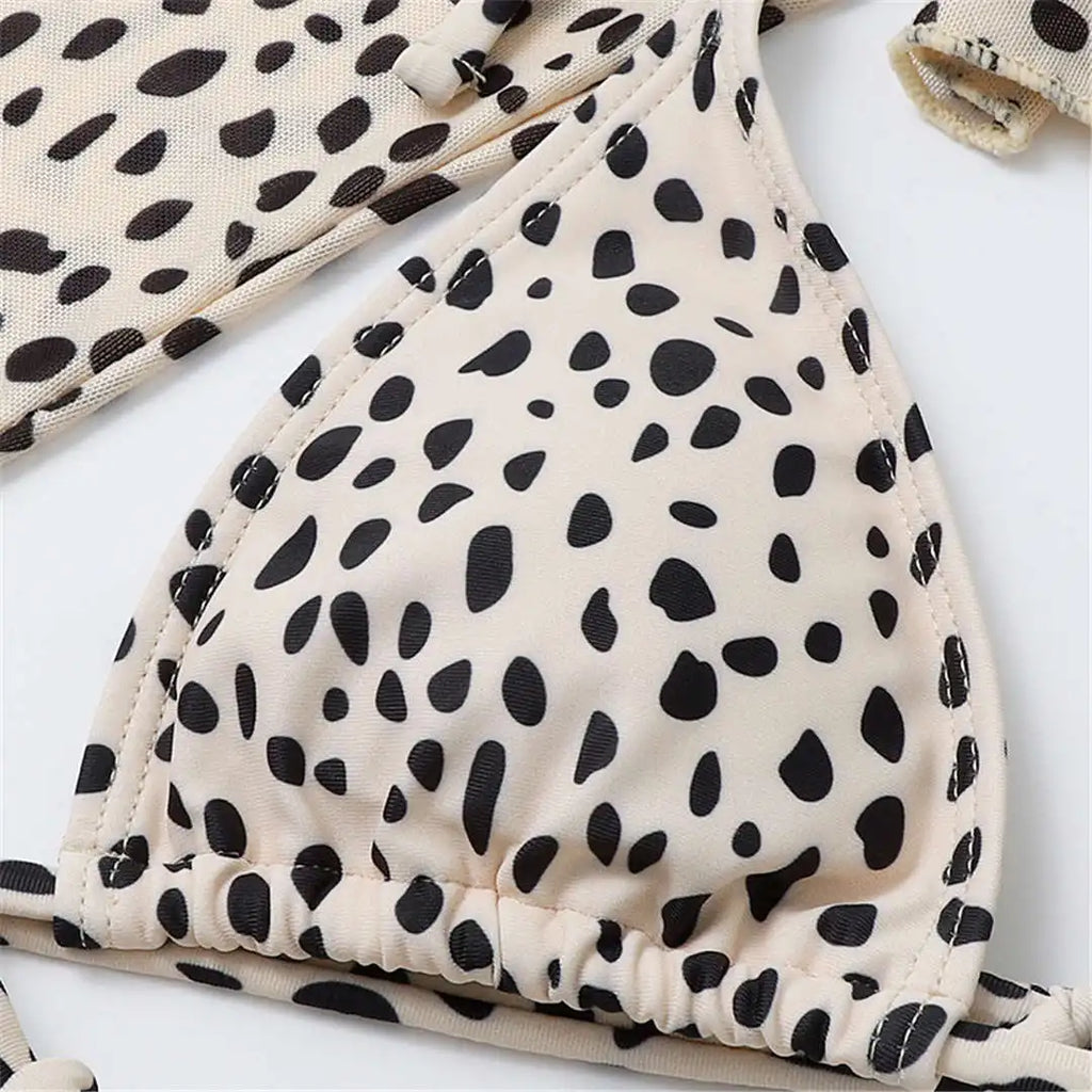 An elegant three-piece swimwear featuring a bold leopard print, long-sleeve top, and matching bikini set, designed for a feminine yet confident and stylish beach look